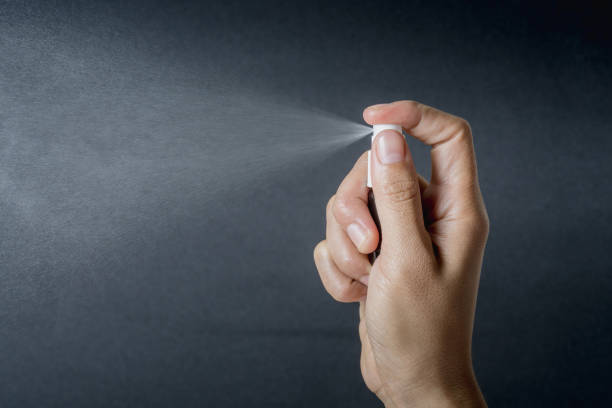 hand hold small spray bottle and spraying