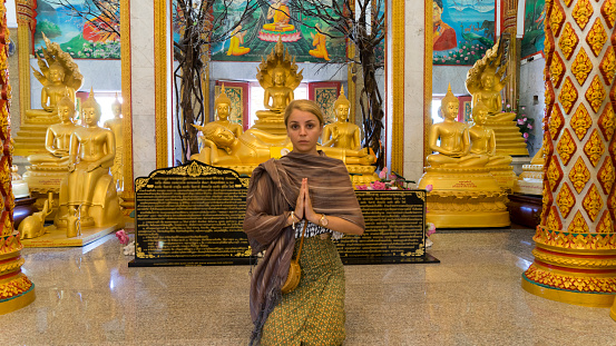 tourist Woman prayer near the  Buddhist Temple