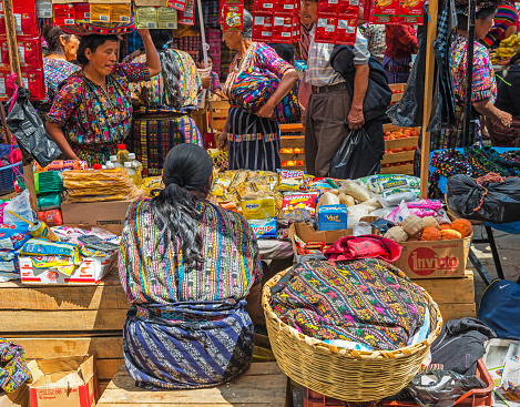 Buyers and sellers on the local market of Solola near Panajachel and the Atitlan Lake with people wearing colorful mayan textiles and clothing, Guatemala.