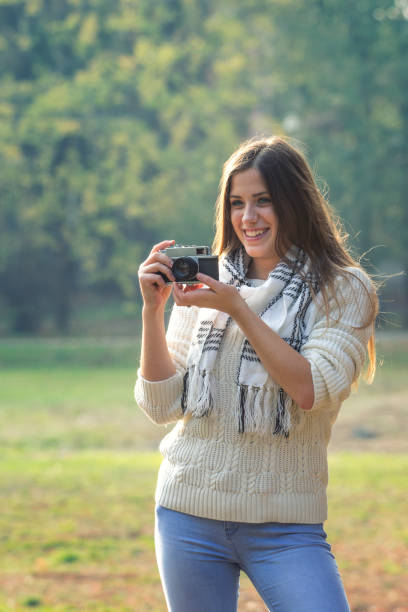 istock Young beautiful girl with camera 871697216