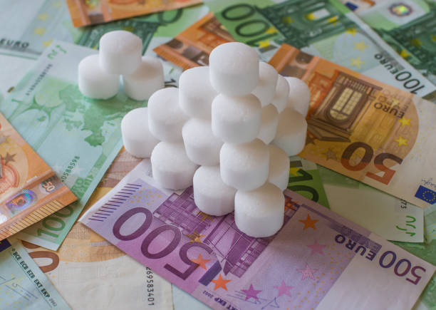 salz-pellets für wasserenthärter auf dem hintergrund der euro-banknoten - water softener stock-fotos und bilder