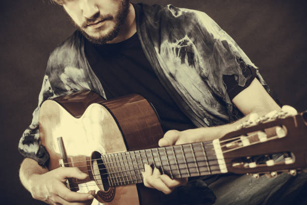 istock Closeup of man playing acoustic guitar 871707708