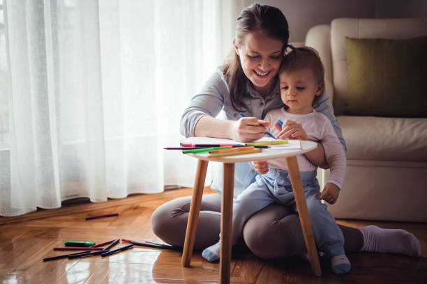 istock Young mother drawing with her baby boy 871710470