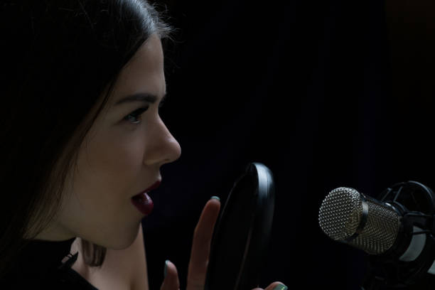 istock Beautiful girl singing In Recording Studio with microphone 871710644