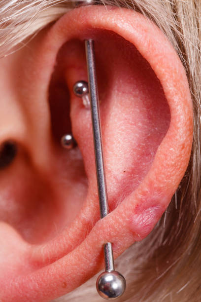 istock Pierced man ear, black plug tunnel, industrial and rook 871710992