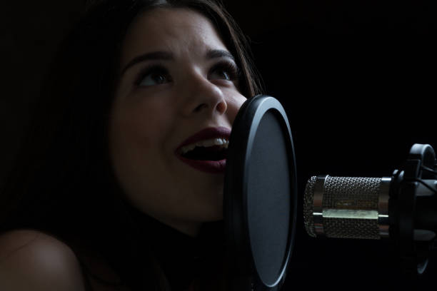 istock Beautiful girl singing In Recording Studio with microphone 871711070