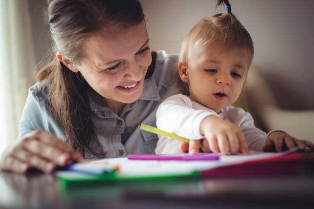 istock Mother drawing with adorable baby 871711932