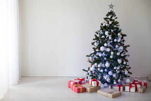 istock Christmas Decor white room new year tree gifts 871714536