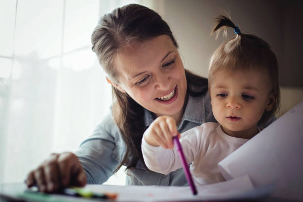 istock Mother drawing with her adorable baby boy 871714834