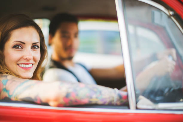 istock Diversity: multiethnic couple in a red vintage car 871714846