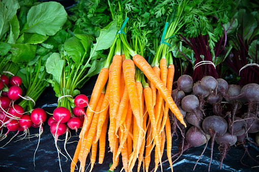 An arrangement of fresh organic root vegetables on display at the Penticton Farmer's Market located in Penticton, British Columbia, Canada.