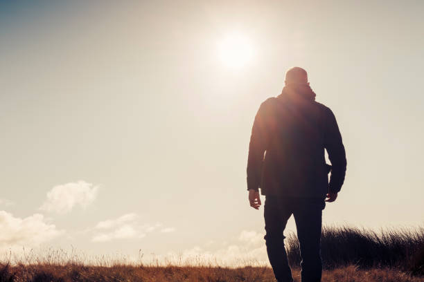 istock Man hiking in Autumn sunshine. 871718180