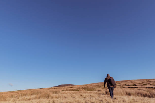 istock Man hiking in Autumn sunshine. 871718294