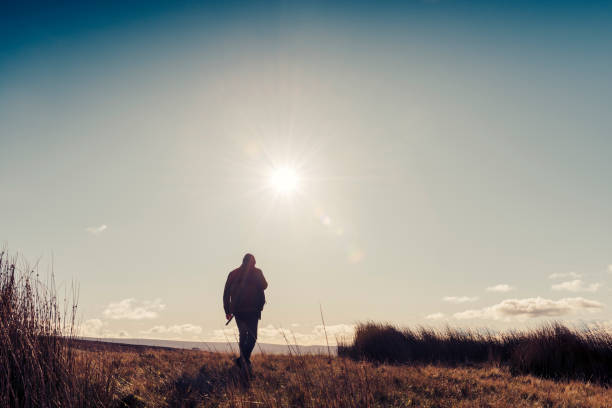 istock Man hiking in Autumn sunshine. 871718360