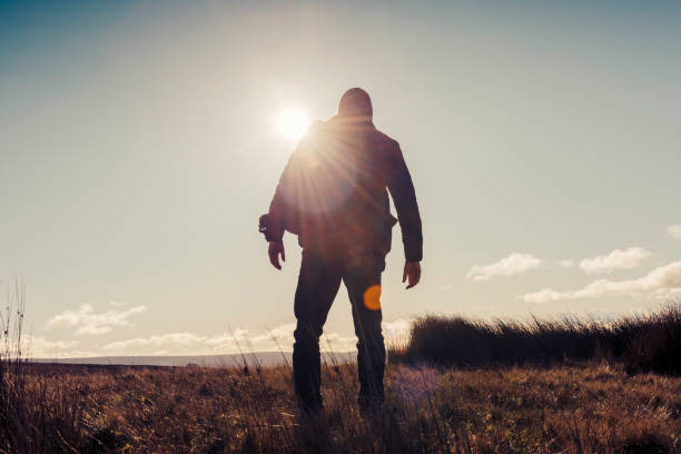 istock Man hiking in Autumn sunshine. 871718370