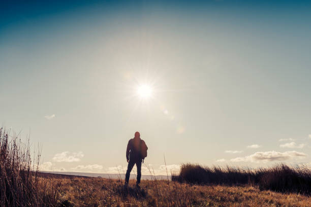 istock Man hiking in Autumn sunshine. 871718380