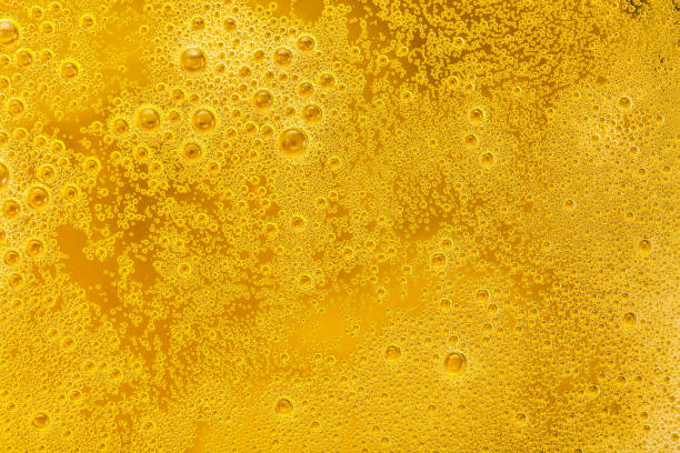istock Close up of beer bubbles and foam as a background 871719100