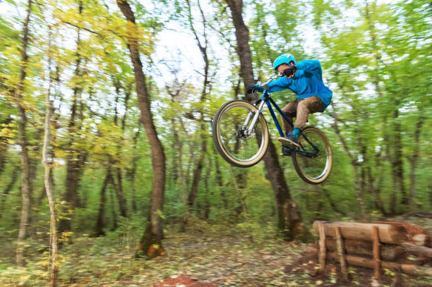 istock a young guy in a helmet flies landed on a bicycle after jumping from a kicker 871720350