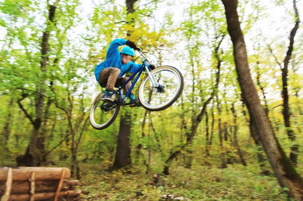 istock a young guy in a helmet flies landed on a bicycle after jumping from a kicker 871722490