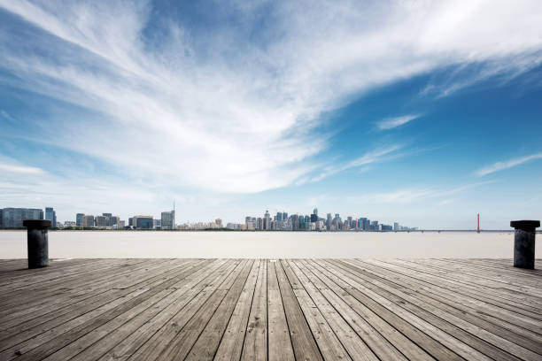 istock empty wooden floor with modern bridge and buildings 871722790