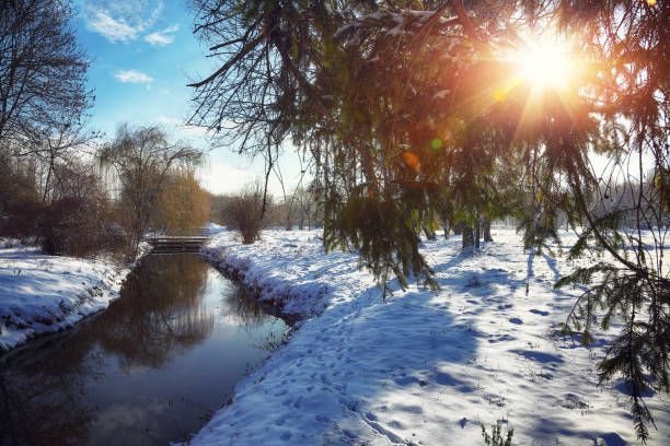 istock Winter landscape by a river during sunset 871726088
