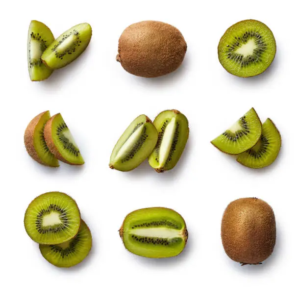 Set of fresh whole and cut kiwi and slices isolated on white background. From top view
