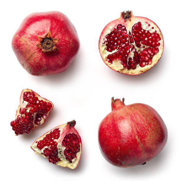 Fresh pomegranate isolated on white background Fresh whole and half of pomegranate isolated on white background from top view pomegranate stock pictures, royalty-free photos & images