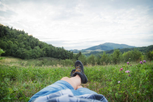 Man taking a break in nature / green field.
