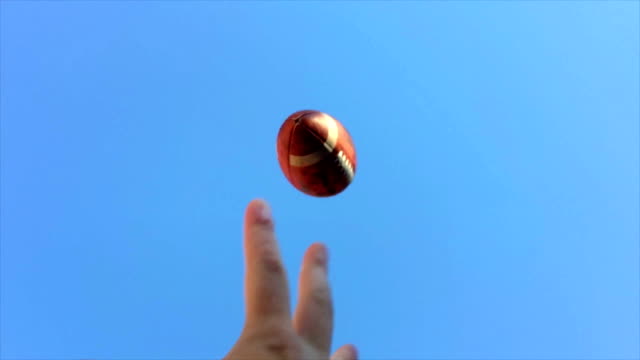 Super slow motion of hands catching football