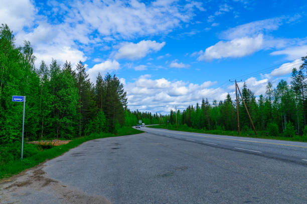 istock Road and a bus stop in Lapland 871749302