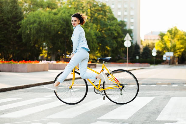 istock Lovely woman with a bicycle on the road 871764068