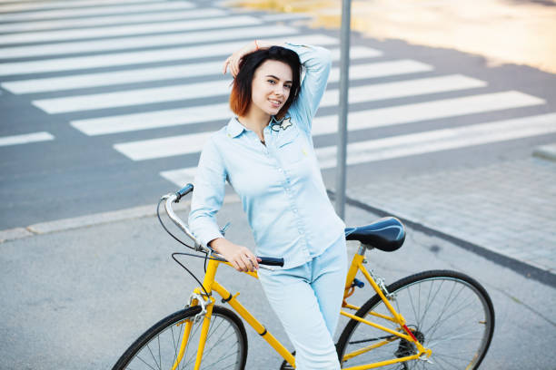 istock Lovely woman with a bicycle on the road 871764074