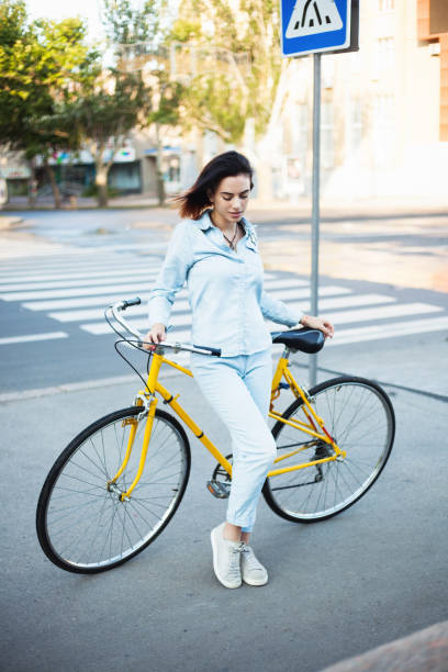 istock Lovely woman with a bicycle on the road 871764084