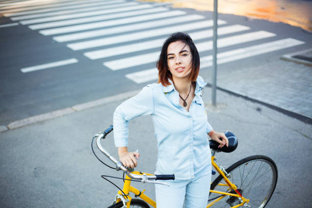 istock Lovely woman with a bicycle on the road 871764090