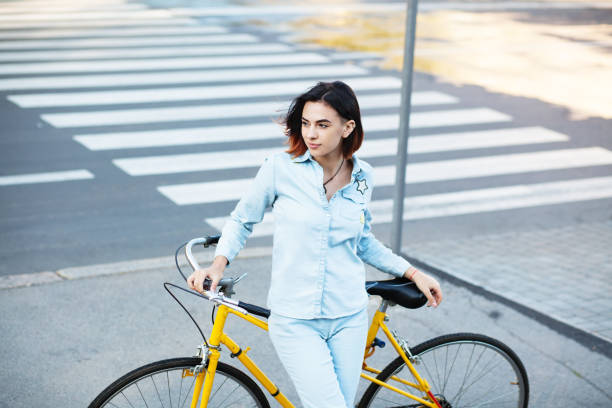 istock Lovely woman with a bicycle on the road 871764110