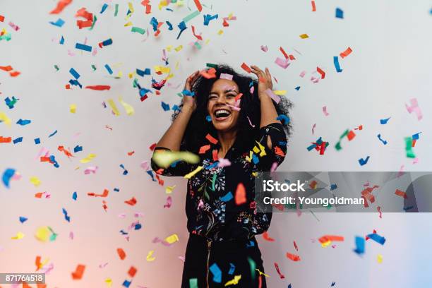 Surprised Woman Standing Indoors While Colorful Confetti Falling Stock Photo - Download Image Now