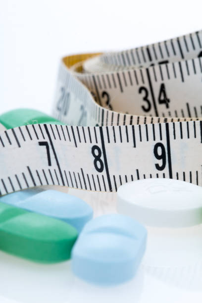 istock Tape measure and Pills 871765306
