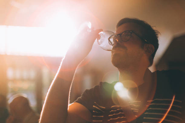 istock One man drinking a glass of white wine 871770838