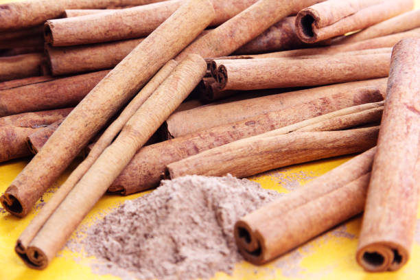 istock heap of cinnamon sticks and cinnamon powder 871771556