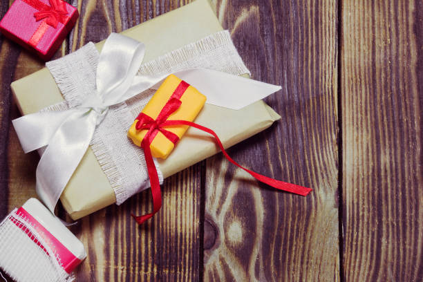 istock gifts in a different packages on a wooden background 871771890