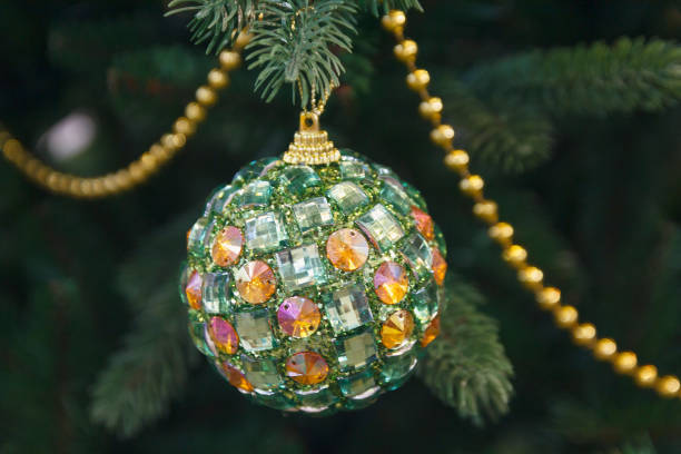 istock Glittering ball on a fir tree close-up. Christmas decorations 871774740