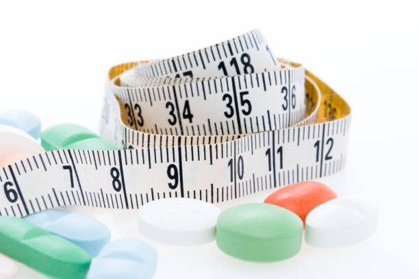 istock Tape measure and Pills 871778258