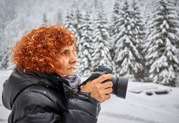istock Tourist woman with camera in wintertime 871778844