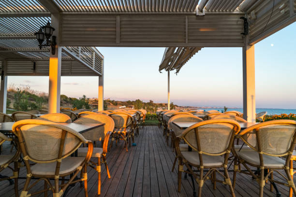 istock chairs and tables on a beach restaurant during sunset 871778896