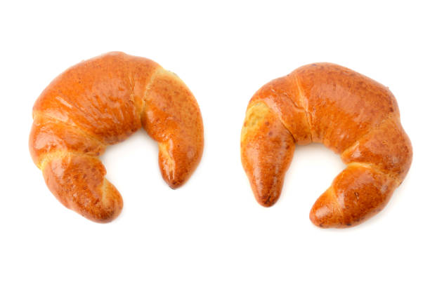 Crescent-shaped bread roll and white background