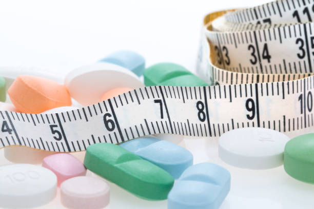 istock Tape measure and Pills 871782396