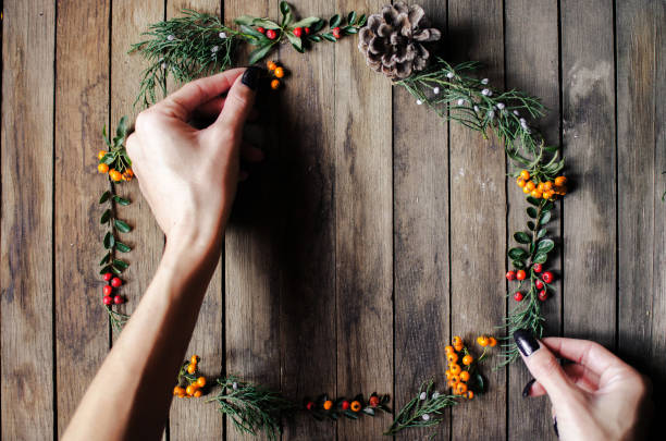 istock Woman making wreath of greenery 871786446