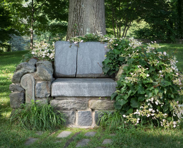istock A Crude Stone Bench with Flowers and Plants Surrounding 871793064