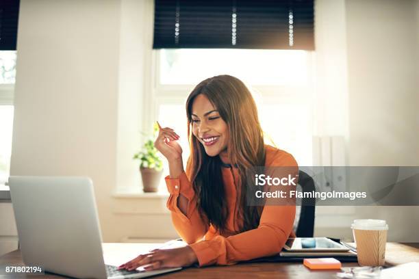 自宅のラップトップに取り組んで笑顔若い女性起業家 - 在宅勤務のストックフォトや画像を多数ご用意 - 在宅勤務, 女性, ノートパソコン