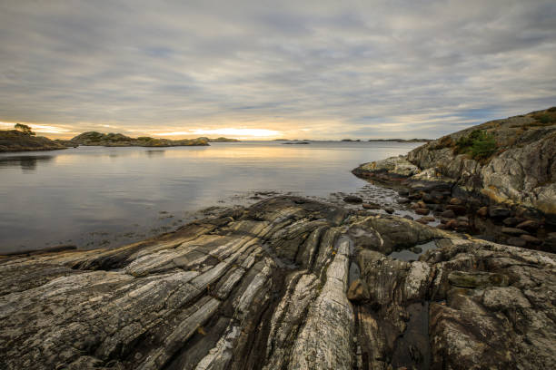 istock Seascape with rocks, sea and clouds. Grimstad in Norway 871802566